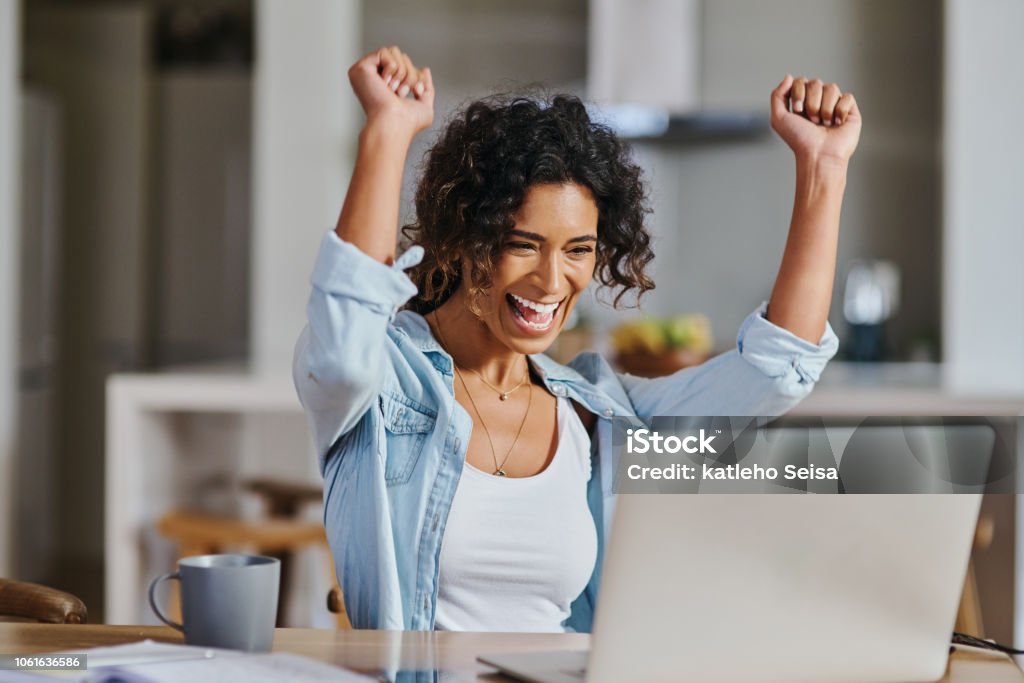 Cropped shot of a young woman celebrating her computer screen