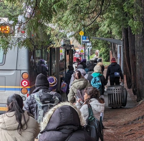 A very long queue of people waiting for the 49 at the stop at Cambie and 49th.