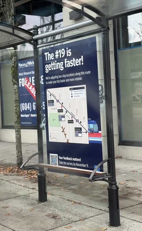 19020BD3-478C-4FAF-8CF4-E1D56E522A0A_1_105_c A large navy blue sign at a bus stop that says "The #19 is getting faster!"